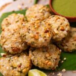 An image of hot and crispy air fryer sabudana vadas placed on a leaf platter and served with green chutney