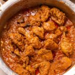 an image of chicken korma in a handi