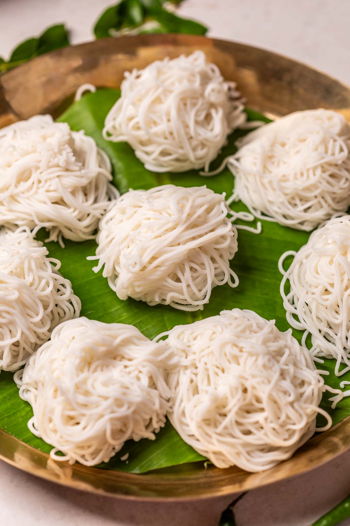 Rice idiyappams served on banana leaf in a plate