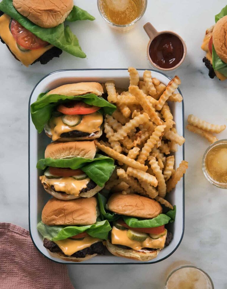 Smash Burgers with crinkly fries and a side of ketchup.