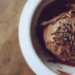Chocolate Ninja Creami protein ice cream scoop topped with shavings.