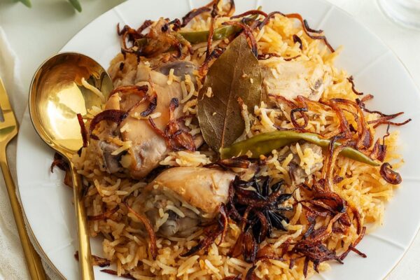Chicken pulao served on a white plate.