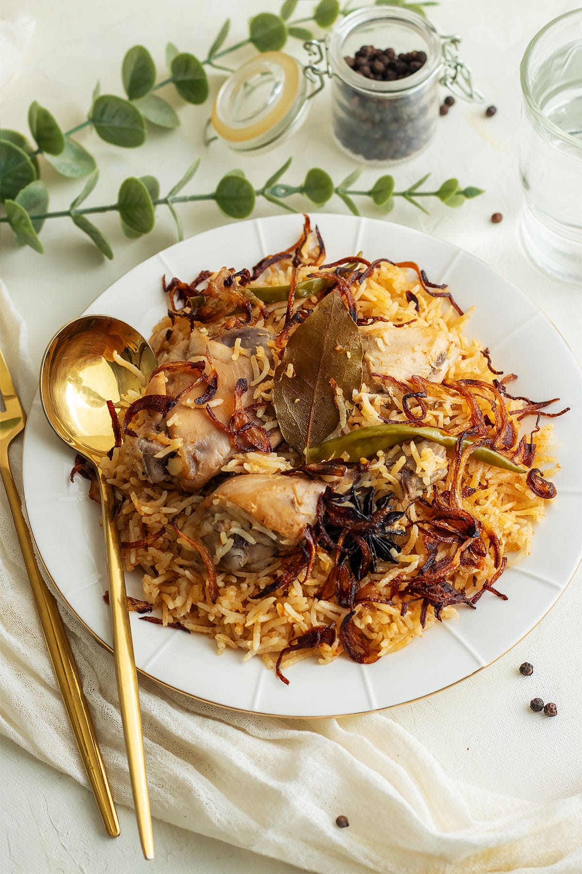 Chicken pulao served on a white plate.