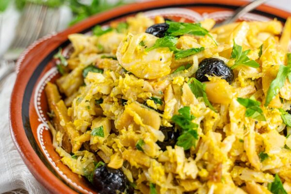Codfish to Brás. Portuguese Cod Fish with Onions, Eggs and Fries + Time-Saving Hack! Bacalhau a bras in a red plate