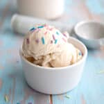 Two scoops of vanilla protein ice cream in a white bowl.