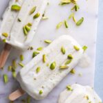 top down view of pista kulfi with some pistachios scattered over top.