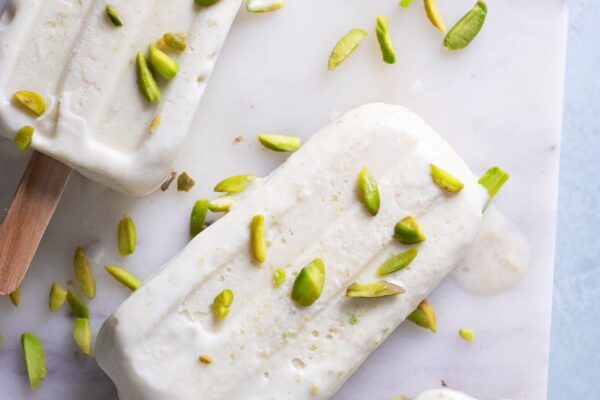top down view of pista kulfi with some pistachios scattered over top.