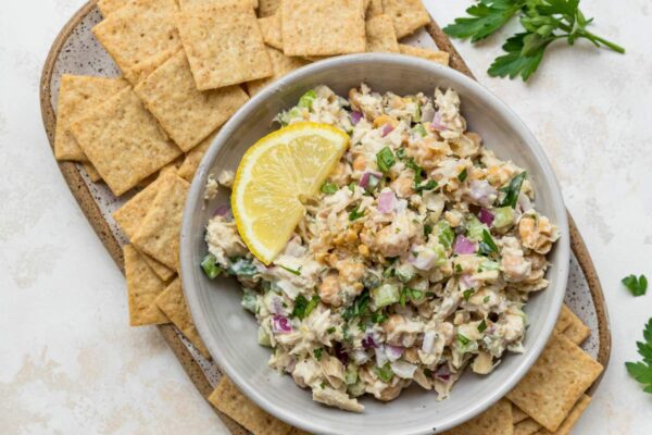 Tuna Chickpea Salad served with crackers and lemon slices.