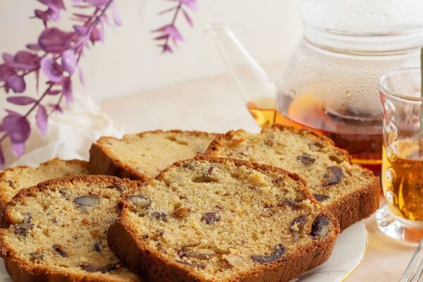 Slices of date cake with nuts on a white plate.
