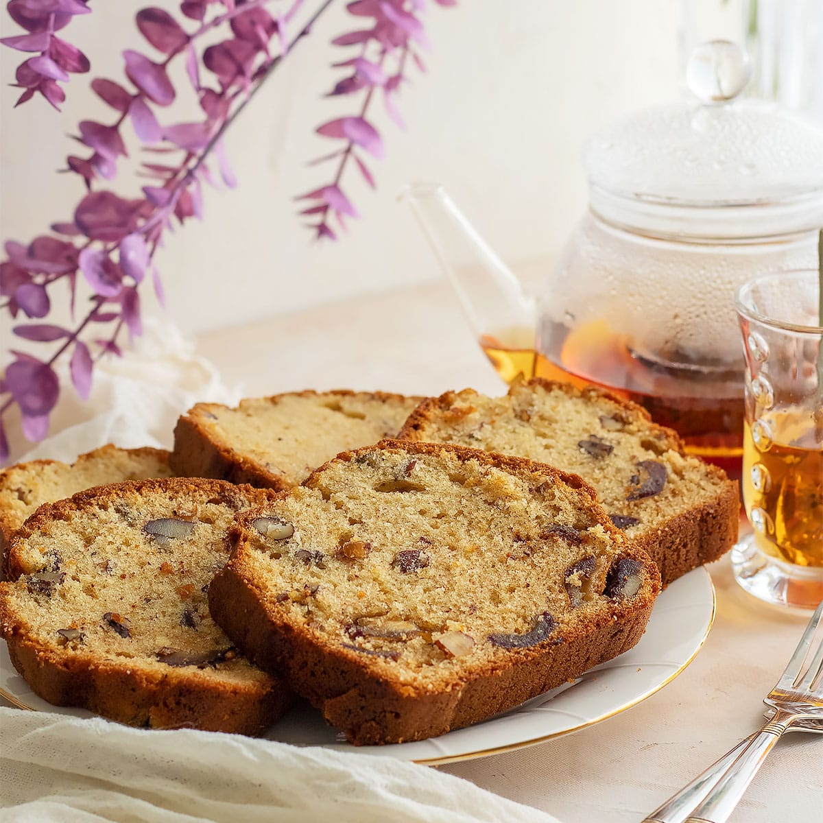 Slices of date cake with nuts on a white plate.