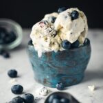 Blueberry and vanilla ice cream in a handmade blue bowl