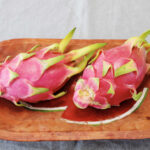 pink dragon fruit in wooden bowl