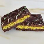 Dubai chocolate bar cut in half on a white countertop