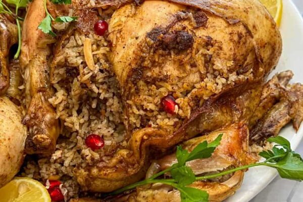 Jaj mahshi rice stuffed chicken on a platter