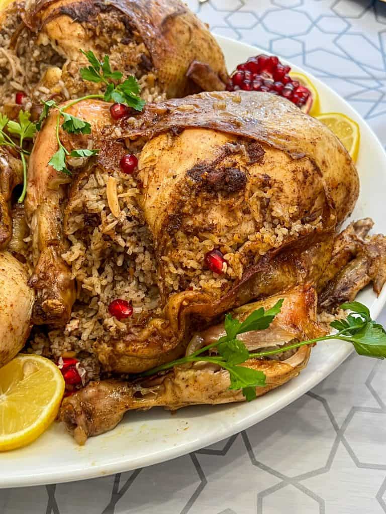 Jaj mahshi rice stuffed chicken on a platter