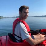 Tim sitting in a red kayak.