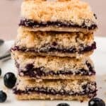 A stack of Keto Blueberry Breakfast Bars on a white plate.