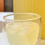 close up of Meyer lemon lemonade with ice served in a double walled glass