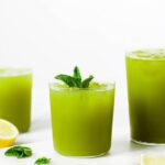 Three glasses of green juice with mint leaves