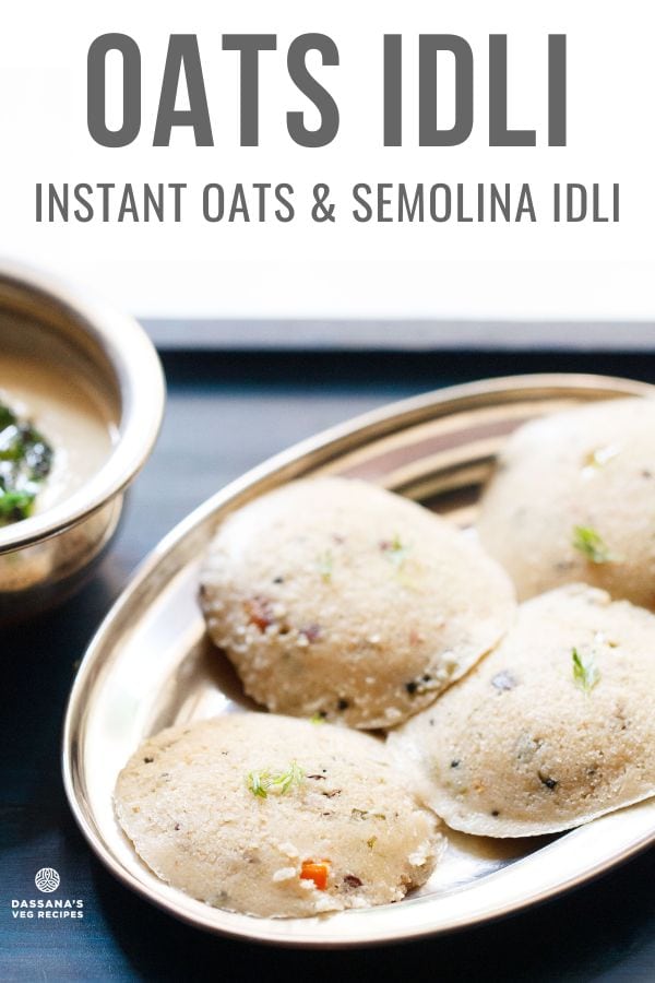 Four round oats idli arranged on silver plate on a dark blue wooden tray with coconut chutney in a silver bowl.