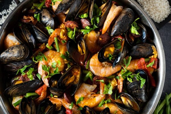 Paella with chicken, chorizo and seafood