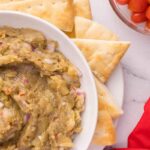 bowl of roasted eggplant dip surrounded by pita chips