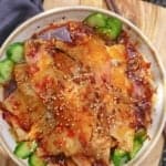 slices of pork over cucumber in a spicy dressing.