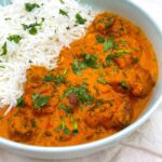 A bowl of white rice and butter chicken
