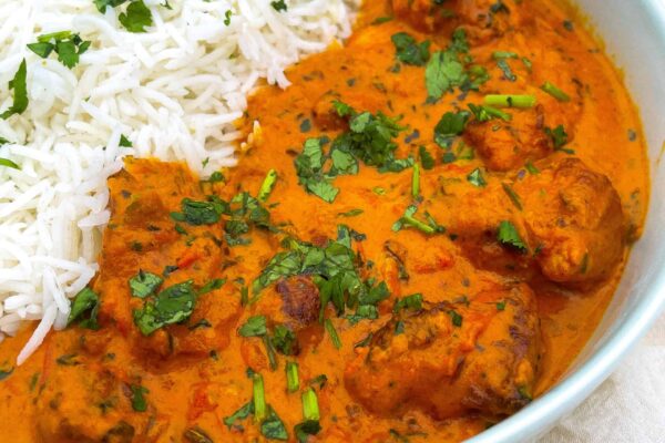A bowl of white rice and butter chicken