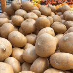 A pile of jicama in a Mexican grocery store
