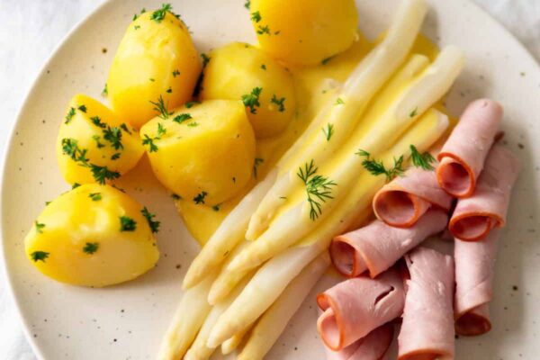 White asparagus on a plate to help celebrate the German white asparagus season.