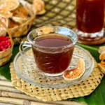 A cup of bael tea and a tall glass of chilled bael juice.