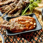 Thai beef satay dipped into peanut sauce.
