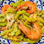 Bitter melon stir fry with egg and shrimp served.
