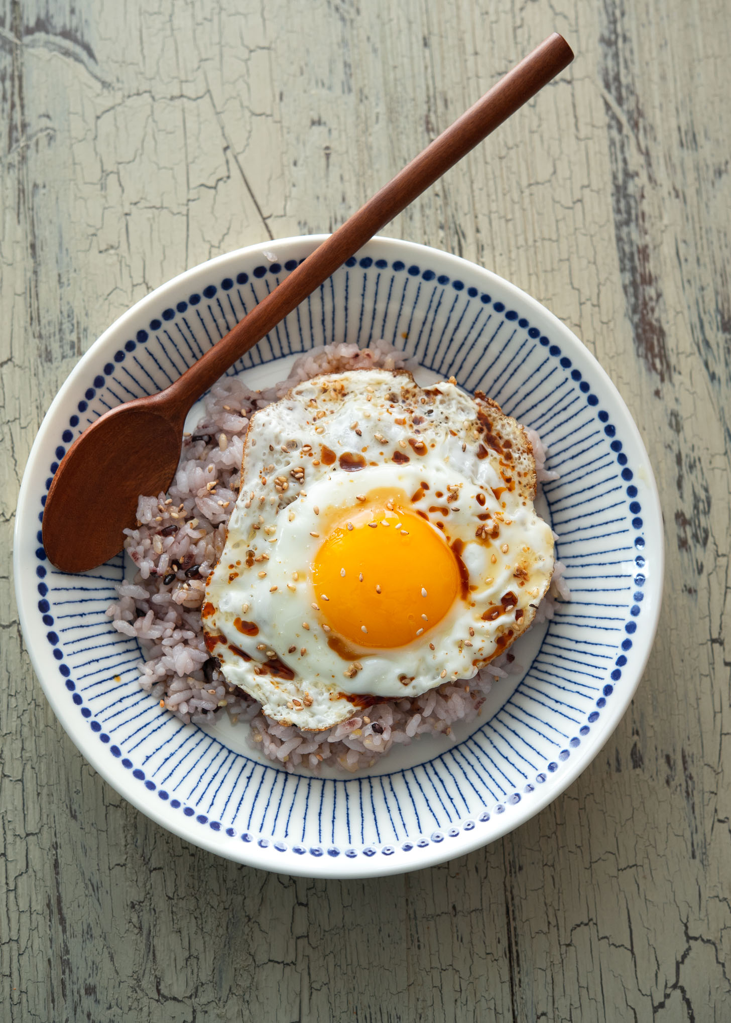 Gyeran bap served in a bowl with fried egg and sesame seed garnish.