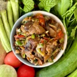 Jeow het, a Lao mushroom dipping sauce, with fresh vegetables and mackerel fish.