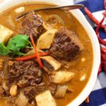 a bowl of massaman curry with beef