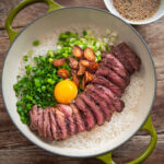Korean pot rice with grilled steak served in a pot.