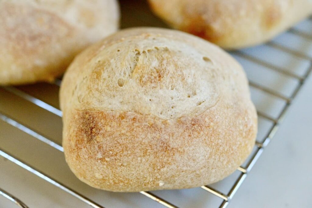 sourdough roll on cooling rack