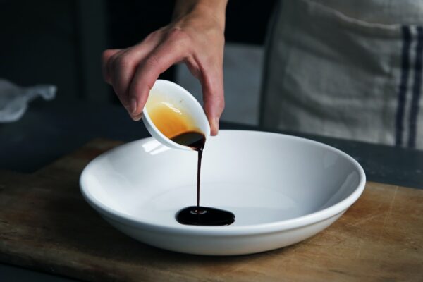soy sauce dripping into bowl