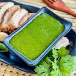 Thai cilantro sauce served with a side of grilled pork and fresh cilantro.