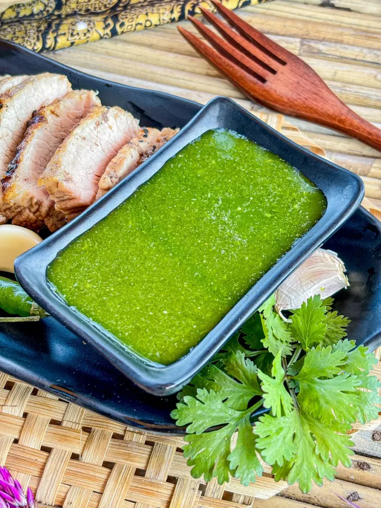 Thai cilantro sauce served with a side of grilled pork and fresh cilantro.