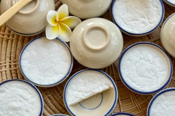 Thai coconut pudding, kanom tuay, in small ceramic bowls.