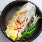 White kimchi (baek kimchi) in a serving bowl.