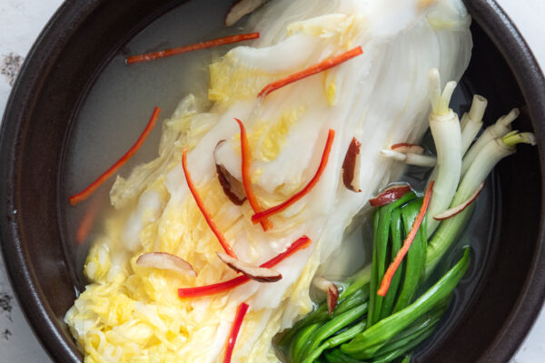 White kimchi (baek kimchi) in a serving bowl.