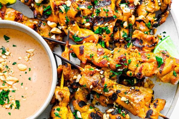 Chicken satay on a plate.