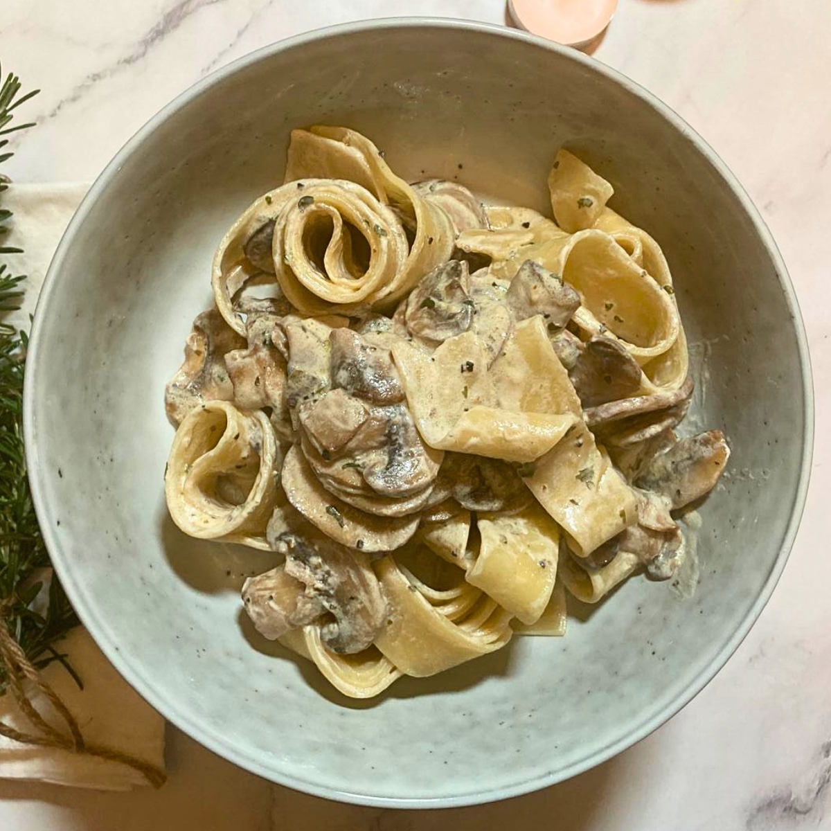 Bowl of mushroom pappardelle with garlic sauce.