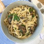 Bowl filled with mushroom spinach pasta.