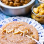 sooji ka halwa in a plate with chana and aloo in the background