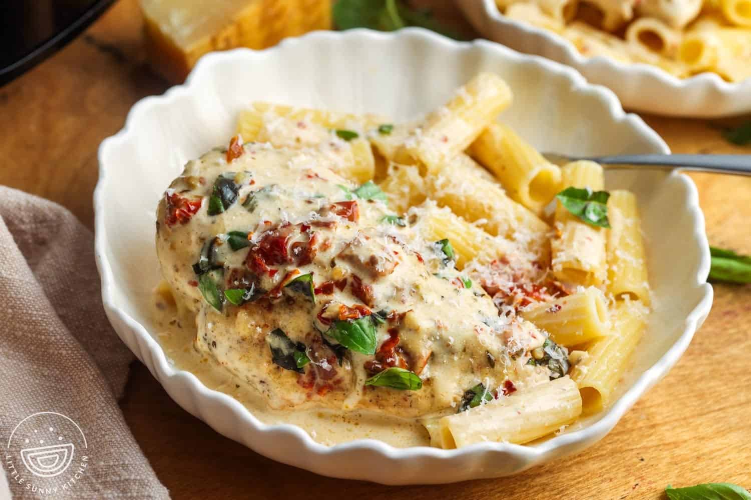 Easy Crockpot Marry Me Chicken Recipe 1 a bowl of pasta with a whole chicken breast. The chicken breast is cooked